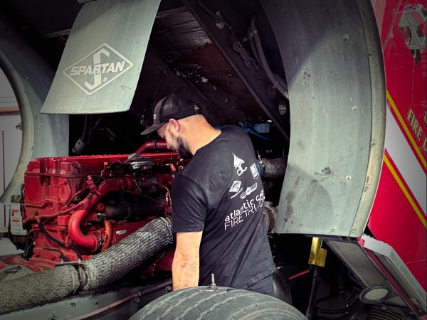 Technician servicing firetruck engine.
